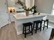 Modern kitchen island with white countertops and black stools, perfect for casual dining at 1311 S Moody Ave # 1, Tampa, FL 33629