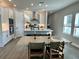 Open-concept kitchen and dining area with modern appliances and plenty of natural light at 1311 S Moody Ave # 1, Tampa, FL 33629
