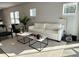 Sun-filled living area with modern decor, a comfortable white sofa, and stylish accent chairs at 1311 S Moody Ave # 1, Tampa, FL 33629