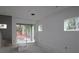 Open-concept living space with sliding glass doors leading to backyard, awaiting personalized finishing at 1311 S Moody Ave # 1, Tampa, FL 33629