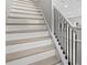 Staircase with white risers, natural wood treads, and modern black metal railings at 1311 S Moody Ave # 1, Tampa, FL 33629