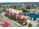 Stunning aerial of a multi-story condo near a marina with a beautiful swimming pool at 13235 Gulf Blvd # 502, Madeira Beach, FL 33708