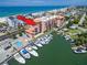 Aerial view of waterfront condos with marina and pool, near beaches at 13235 Gulf Blvd # 502, Madeira Beach, FL 33708