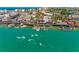 Aerial view showcases turquoise water, waterfront shops, docks and exciting jet ski rentals at 13235 Gulf Blvd # 502, Madeira Beach, FL 33708