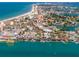 Aerial view showcases beach, ocean, waterfront shops, docks and exciting jet ski rentals at 13235 Gulf Blvd # 502, Madeira Beach, FL 33708