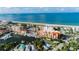 Aerial view featuring a marina with boat docks and condos near a scenic beach at 13235 Gulf Blvd # 502, Madeira Beach, FL 33708