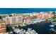 Aerial view featuring a marina with boat docks and condos near a scenic beach at 13235 Gulf Blvd # 502, Madeira Beach, FL 33708