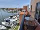 Balcony with a table and seating overlooking the marina at 13235 Gulf Blvd # 502, Madeira Beach, FL 33708
