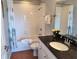 Bathroom featuring a shower-tub combination, dark countertop and vanity with a chrome faucet at 13235 Gulf Blvd # 502, Madeira Beach, FL 33708