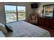 Bedroom with a large bed and a view of the water at 13235 Gulf Blvd # 502, Madeira Beach, FL 33708