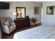Bedroom with a full dresser, mirror, reading chair and a view into the hallway at 13235 Gulf Blvd # 502, Madeira Beach, FL 33708