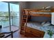 Bedroom with wooden bunk beds and a view of the harbor from the balcony at 13235 Gulf Blvd # 502, Madeira Beach, FL 33708