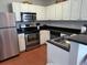 Bright kitchen featuring stainless steel appliances and a tile floor at 13235 Gulf Blvd # 502, Madeira Beach, FL 33708