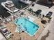 Aerial view of a beautiful pool and hot tub area with multiple boats docked nearby at 13235 Gulf Blvd # 502, Madeira Beach, FL 33708