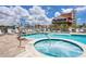 Charming pool and hot tub with a poolside view of the boats in the harbor at 13235 Gulf Blvd # 502, Madeira Beach, FL 33708