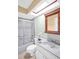 Bright bathroom with a sleek shower, skylight, and white vanity at 1353 Camelot Ct, Palm Harbor, FL 34684