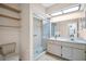Bright bathroom features tiled shower, vanity with storage, and updated fixtures for a clean design at 1353 Camelot Ct, Palm Harbor, FL 34684