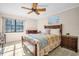 Comfortable bedroom with a ceiling fan, plush carpet, and a serene atmosphere for relaxation at 1353 Camelot Ct, Palm Harbor, FL 34684