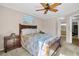 Inviting bedroom with a ceiling fan, neutral paint, and large windows for natural light at 1353 Camelot Ct, Palm Harbor, FL 34684