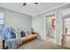 Cozy bedroom featuring a plush futon sofa and an adjacent bathroom entrance at 1353 Camelot Ct, Palm Harbor, FL 34684