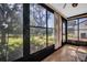 Sun-drenched bonus lanai featuring large windows with a view of the lush backyard at 1353 Camelot Ct, Palm Harbor, FL 34684