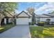 Charming single-story home featuring a well-maintained lawn, two-car garage, and welcoming front entrance at 1353 Camelot Ct, Palm Harbor, FL 34684
