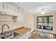 Lovely eat-in kitchen boasting updated appliances, countertops, and breakfast area with a large window at 1353 Camelot Ct, Palm Harbor, FL 34684