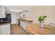 Updated kitchen with granite countertops, stainless steel appliances, and ample cabinet space for storage at 1353 Camelot Ct, Palm Harbor, FL 34684