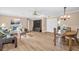 Open-concept living and dining area boasts wood floors and light-filled space perfect for entertaining at 1353 Camelot Ct, Palm Harbor, FL 34684