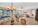 Bright and airy living space featuring hardwood floors, a dining area, and sliding doors to the patio at 1353 Camelot Ct, Palm Harbor, FL 34684
