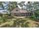 A sprawling backyard with a deck, patio, and screened pool, perfect for outdoor living at 13785 Oak Forest S Blvd, Seminole, FL 33776