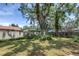 Lush backyard with green grass, mature trees, and well-maintained landscaping, offering privacy at 13785 Oak Forest S Blvd, Seminole, FL 33776