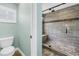 Modern bathroom featuring a glass enclosed shower with tiled walls and a built-in seat at 13785 Oak Forest S Blvd, Seminole, FL 33776