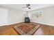 Inviting bedroom with wood-look floors, natural light, and a comfortable recliner at 13785 Oak Forest S Blvd, Seminole, FL 33776