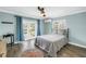 Light-filled bedroom featuring cool blue walls, French doors to backyard, and wood-look floors at 13785 Oak Forest S Blvd, Seminole, FL 33776