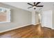 Bright bedroom with wood-look floors, a ceiling fan, and a closet at 13785 Oak Forest S Blvd, Seminole, FL 33776