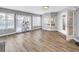 Bright bonus room featuring laminate wood flooring, large windows, and French doors at 13785 Oak Forest S Blvd, Seminole, FL 33776