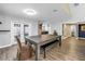 Bright dining room with gray walls, laminate flooring, a farmhouse dining table, and adjacent access to the kitchen at 13785 Oak Forest S Blvd, Seminole, FL 33776