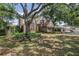Charming home with mature trees, well-manicured landscaping, brick accents, and a two-car garage at 13785 Oak Forest S Blvd, Seminole, FL 33776