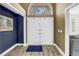 Bright foyer with wood floors, arched window over double doors, and a view into living spaces at 13785 Oak Forest S Blvd, Seminole, FL 33776