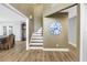 Bright foyer showcasing wood flooring, a staircase, and decorative wall accents at 13785 Oak Forest S Blvd, Seminole, FL 33776