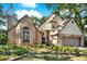 Charming two-story home with brick accents, arched windows, and a well-manicured lawn at 13785 Oak Forest S Blvd, Seminole, FL 33776