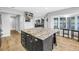 Bright and open kitchen area with a large center island, stainless appliances, and adjacent rooms at 13785 Oak Forest S Blvd, Seminole, FL 33776