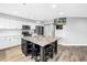 Spacious kitchen featuring a large center island, stainless appliances, and an adjacent dining area at 13785 Oak Forest S Blvd, Seminole, FL 33776