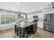 Bright kitchen featuring white cabinets, stainless steel appliances, granite counters, and a large island at 13785 Oak Forest S Blvd, Seminole, FL 33776