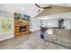 Open-concept living room with fireplace, wood floors, ample seating, and adjacent dining area at 13785 Oak Forest S Blvd, Seminole, FL 33776