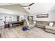 Spacious living area with wood floors, dining table, and comfortable seating, filled with natural light at 13785 Oak Forest S Blvd, Seminole, FL 33776