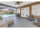 Covered patio featuring a grill, outdoor seating, and access to the screened pool area at 13785 Oak Forest S Blvd, Seminole, FL 33776