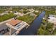 This waterfront property features a dock, pool and patio perfect for entertaining, with lush landscaping surrounding the property at 13878 Allamanda Cir, Port Charlotte, FL 33981