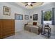 Comfortable guest bedroom with a daybed, wicker furniture and rocking chair for relaxing by the window at 13878 Allamanda Cir, Port Charlotte, FL 33981